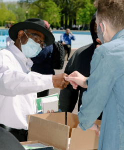 two racially diverse people interacting with a box and driver's cooperative marketing material