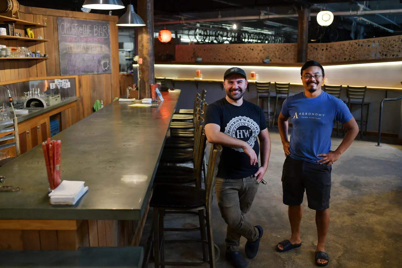 Founders, Spencer Mewherter and Christopher Ly standing by the bar